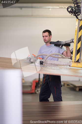 Image of worker in a factory of wooden furniture