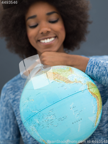 Image of black woman holding Globe of the world