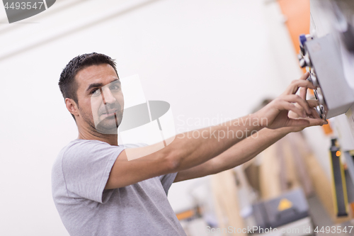 Image of worker in a factory of wooden furniture