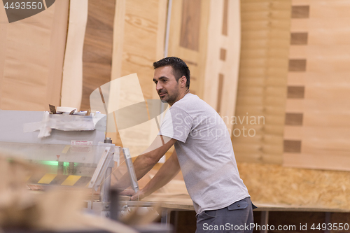 Image of worker in a factory of wooden furniture