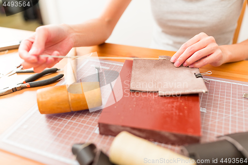 Image of Woman leather bag at home