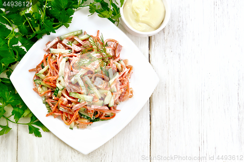 Image of Salad of sausage and spicy carrots with mayonnaise on light boar