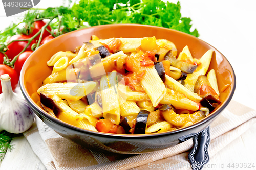 Image of Pasta penne with eggplant and tomatoes on towel