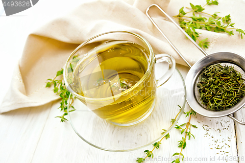 Image of Tea of thyme in cup on board