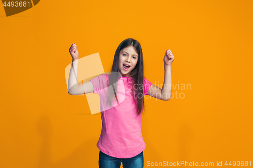 Image of Happy success teen girl celebrating being a winner. Dynamic energetic image of female model