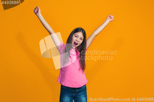 Image of Happy success teen girl celebrating being a winner. Dynamic energetic image of female model