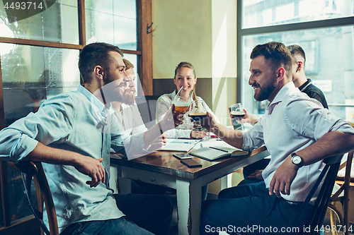 Image of Team job while relaxing in pub.