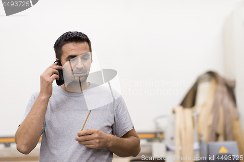 Image of engineer in front of wood cutting machine