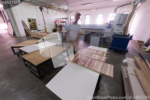 Image of worker in a factory of wooden furniture