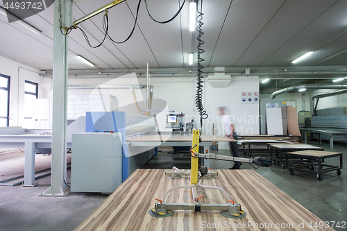 Image of worker in a factory of wooden furniture