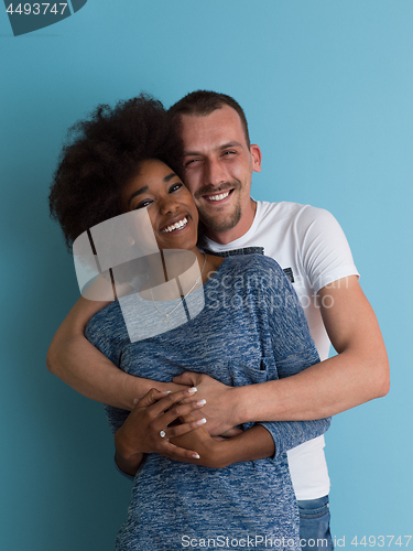 Image of multiethnic couple laughing and hugging