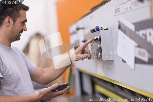 Image of worker in a factory of wooden furniture