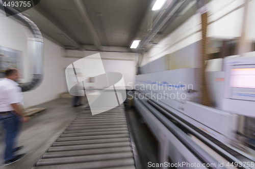 Image of workers in a factory of wooden furniture