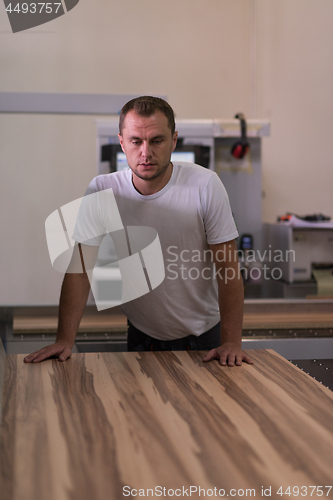 Image of worker in a factory of wooden furniture