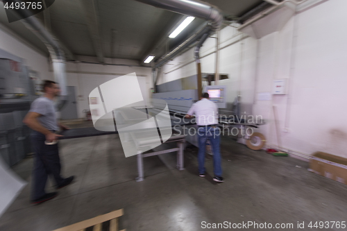 Image of workers in a factory of wooden furniture