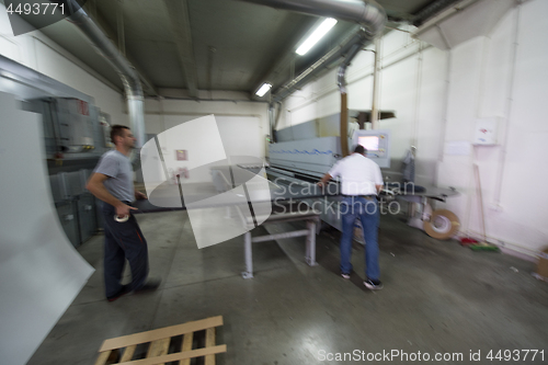 Image of workers in a factory of wooden furniture