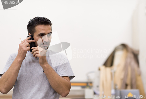 Image of engineer in front of wood cutting machine