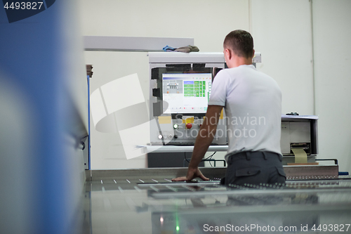 Image of worker in a factory of wooden furniture