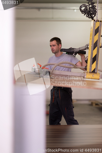 Image of worker in a factory of wooden furniture