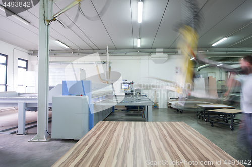 Image of worker in a factory of wooden furniture