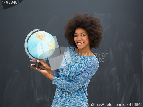 Image of black woman holding Globe of the world