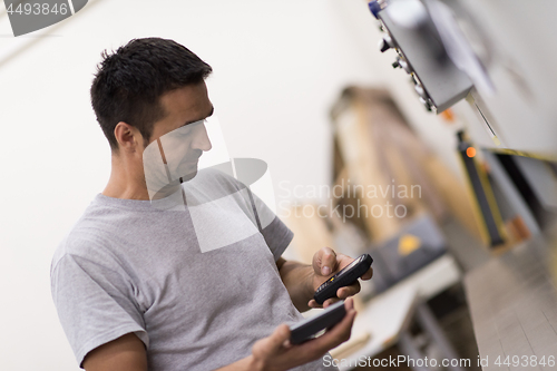 Image of engineer in front of wood cutting machine