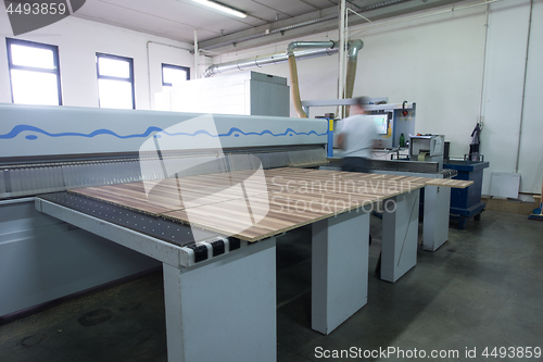 Image of worker in a factory of wooden furniture