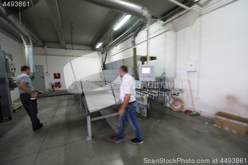 Image of workers in a factory of wooden furniture