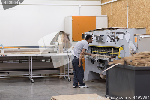 Image of worker in a factory of wooden furniture