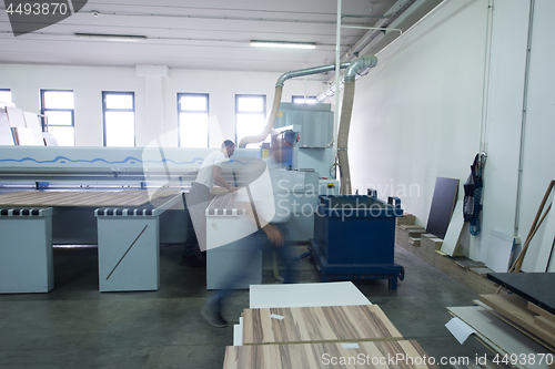 Image of workers in a factory of wooden furniture
