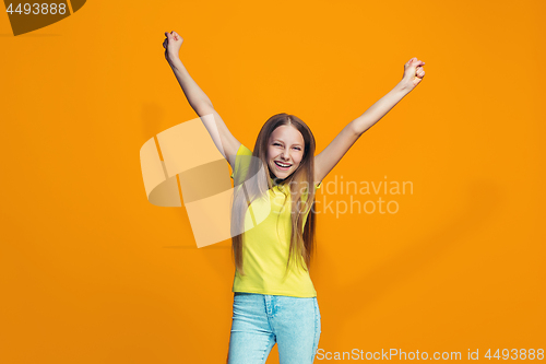 Image of Happy success teen girl celebrating being a winner. Dynamic energetic image of female model