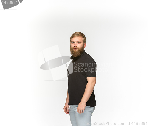 Image of Closeup of young man\'s body in empty black t-shirt isolated on white background. Mock up for disign concept