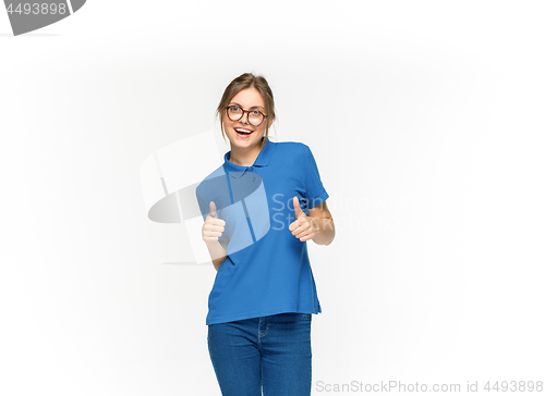 Image of Closeup of young woman\'s body in empty blue t-shirt isolated on white background. Mock up for disign concept