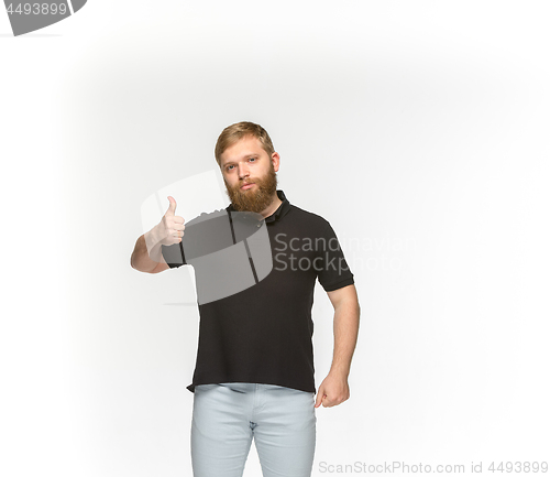 Image of Closeup of young man\'s body in empty black t-shirt isolated on white background. Mock up for disign concept