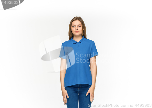 Image of Closeup of young woman\'s body in empty blue t-shirt isolated on white background. Mock up for disign concept