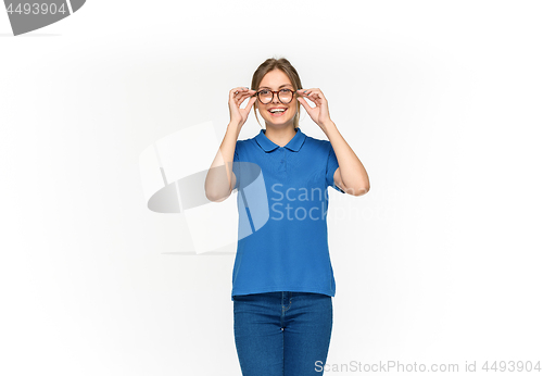 Image of Closeup of young woman\'s body in empty blue t-shirt isolated on white background. Mock up for disign concept