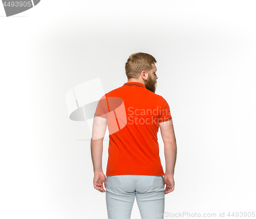 Image of Closeup of young man\'s body in empty red t-shirt isolated on white background. Mock up for disign concept