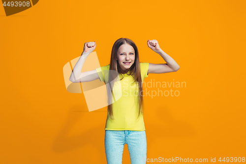 Image of Happy success teen girl celebrating being a winner. Dynamic energetic image of female model