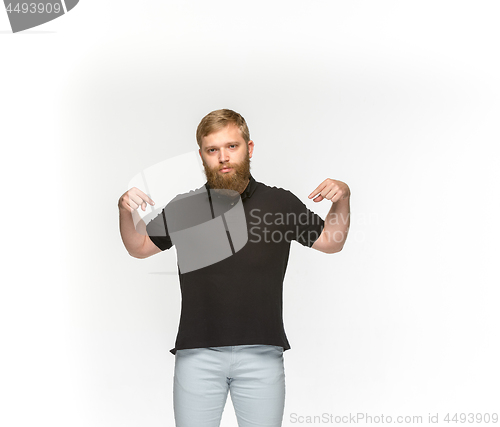 Image of Closeup of young man\'s body in empty black t-shirt isolated on white background. Mock up for disign concept