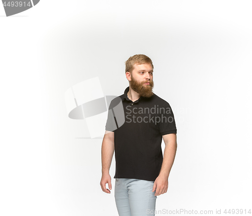 Image of Closeup of young man\'s body in empty black t-shirt isolated on white background. Mock up for disign concept