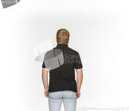 Image of Closeup of young man\'s body in empty black t-shirt isolated on white background. Mock up for disign concept