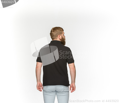 Image of Closeup of young man\'s body in empty black t-shirt isolated on white background. Mock up for disign concept