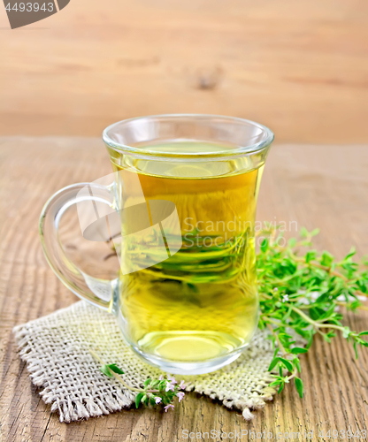 Image of Tea of thyme in mug on wooden board