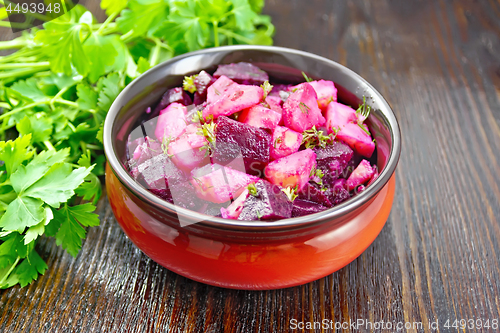 Image of Salad of beets and potatoes in bowl on table