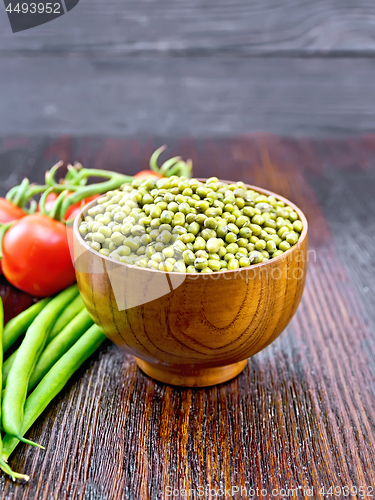 Image of Mung beans  in bowl with vegetables on wooden board