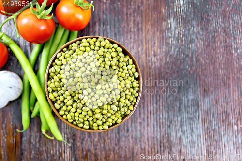 Image of Mung beans  in bowl with vegetables on board top