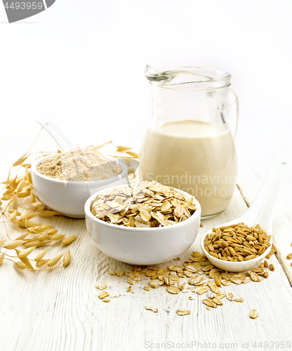 Image of Oat flakes with flour and milk on white board