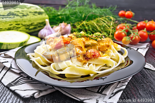 Image of Pasta with goulash in plate on wooden board