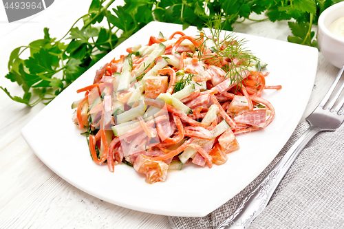 Image of Salad of sausage and spicy carrots with mayonnaise on board