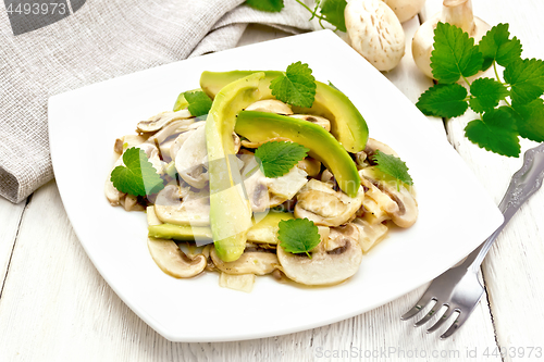 Image of Salad of avocado and champignons on light table